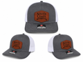 Gray/white trucker hat with orange front patch and Richardson 112 logo
