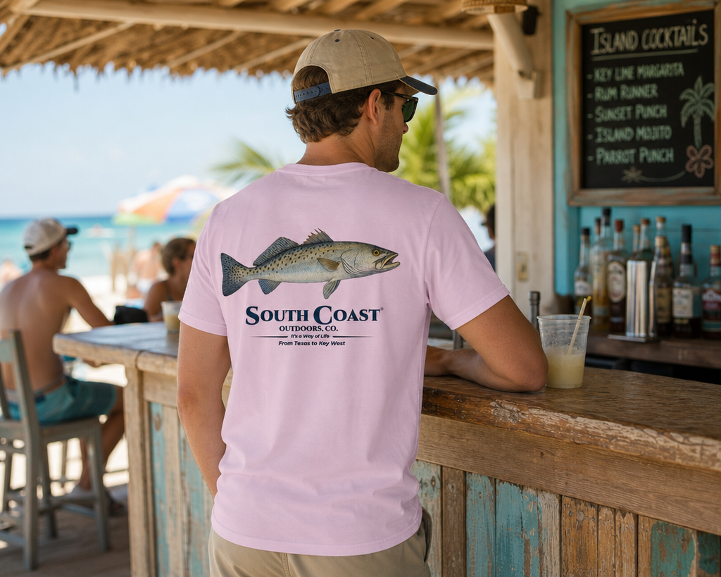 Pink T-shirt back print with speckled sea trout and SOUTH COAST OUTDOORS logo