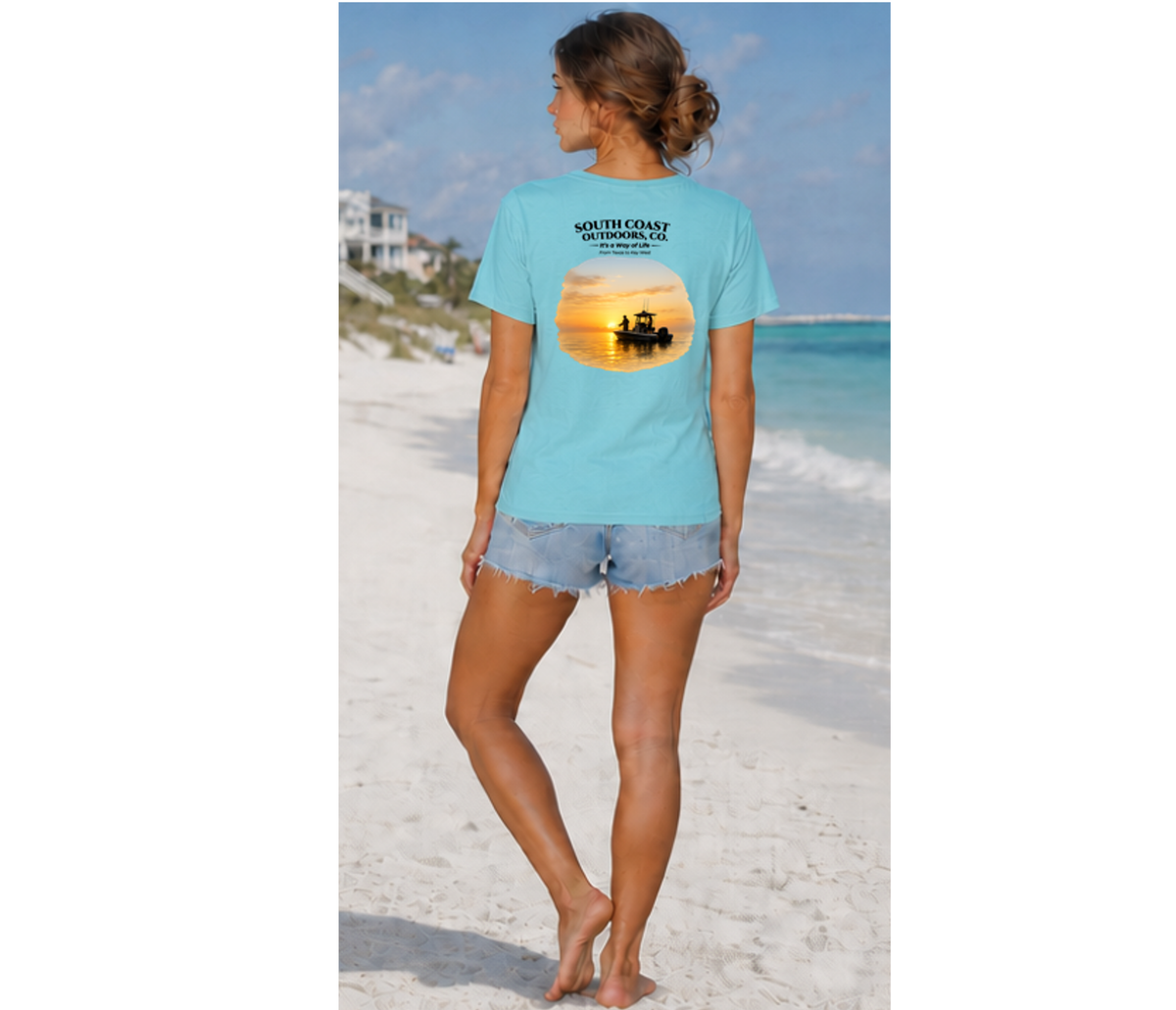 Light blue graphic T-shirt worn by person, back facing the beach