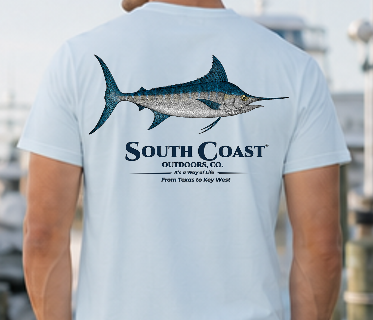 Light blue T-shirt back close-up with marlin graphic and South Coast logo