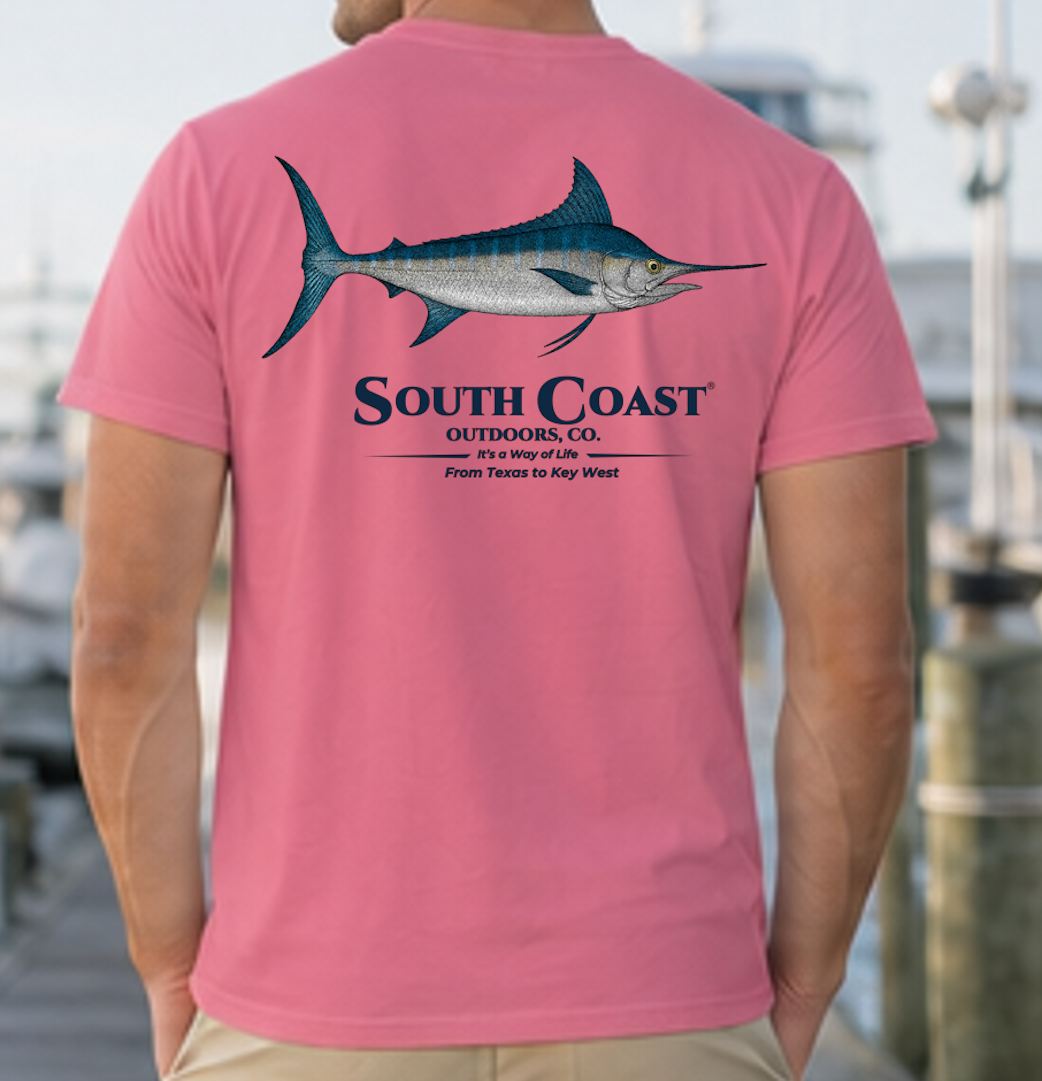 Pink t-shirt with blue marlin fish graphic and South Coast logo on the back