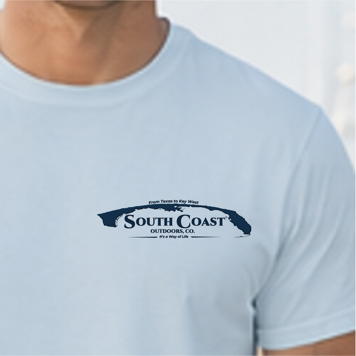 Light blue T-shirt front with South Coast Outdoors logo emblem