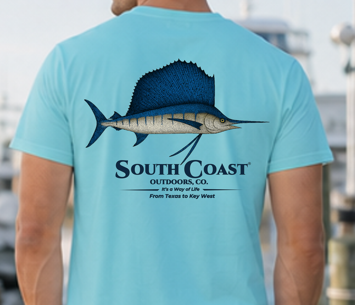 Back view light teal T-shirt featuring sailfish print and South Coast Outdoor Co. text