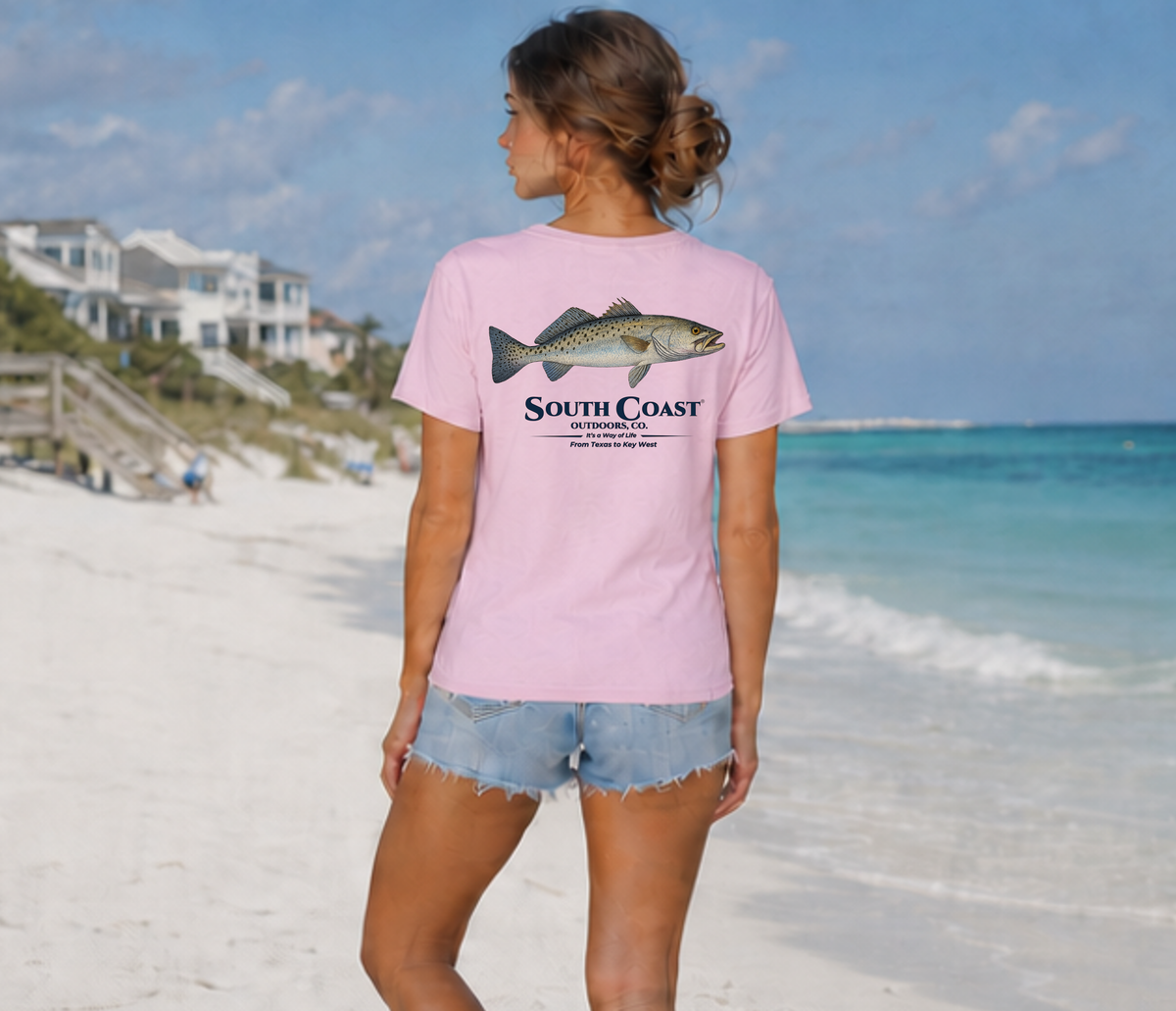 Pink T-shirt with speckled sea trout front graphic, worn by model