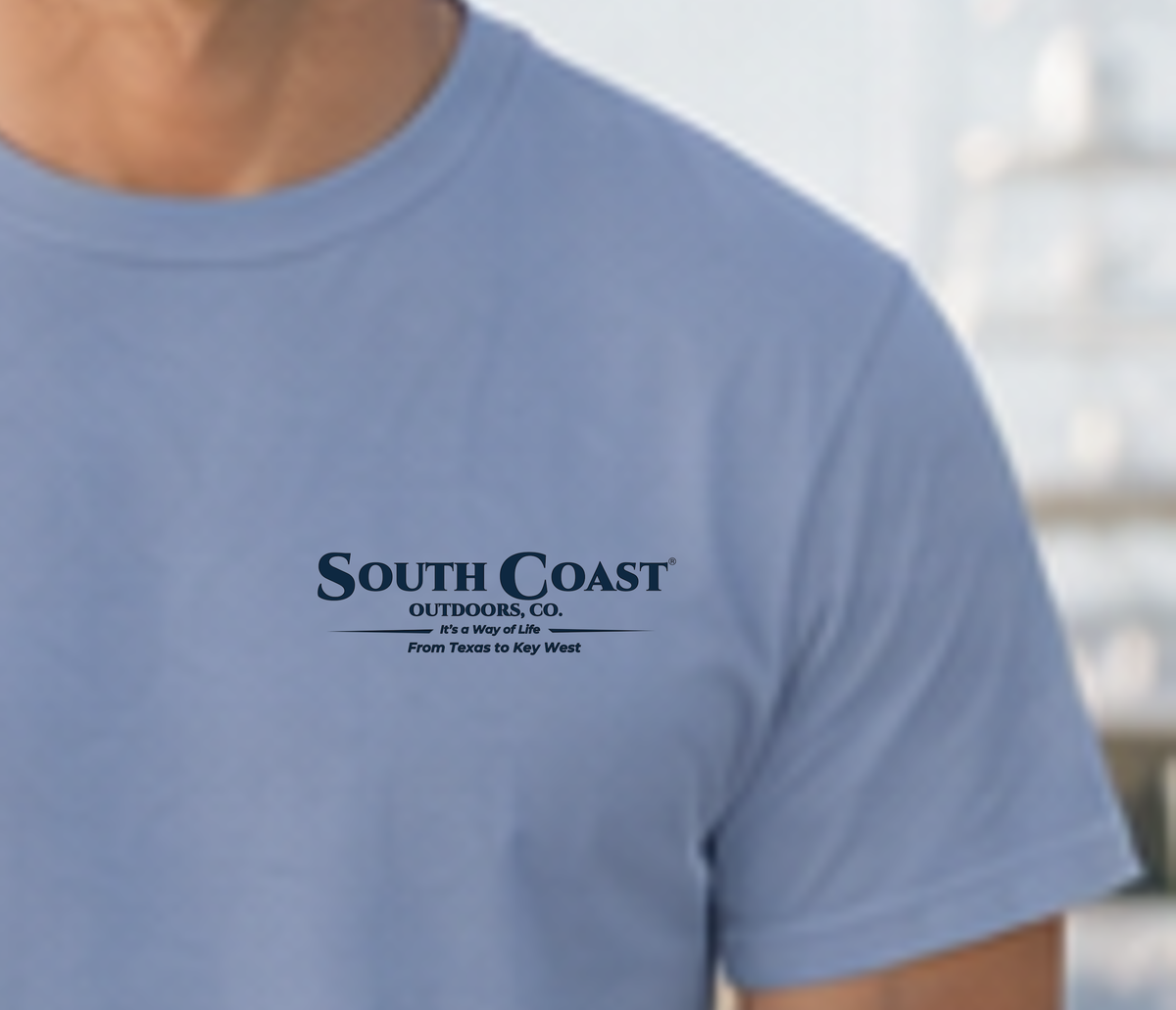 Light blue T-shirt front with South Coast Outdoors Co. logo