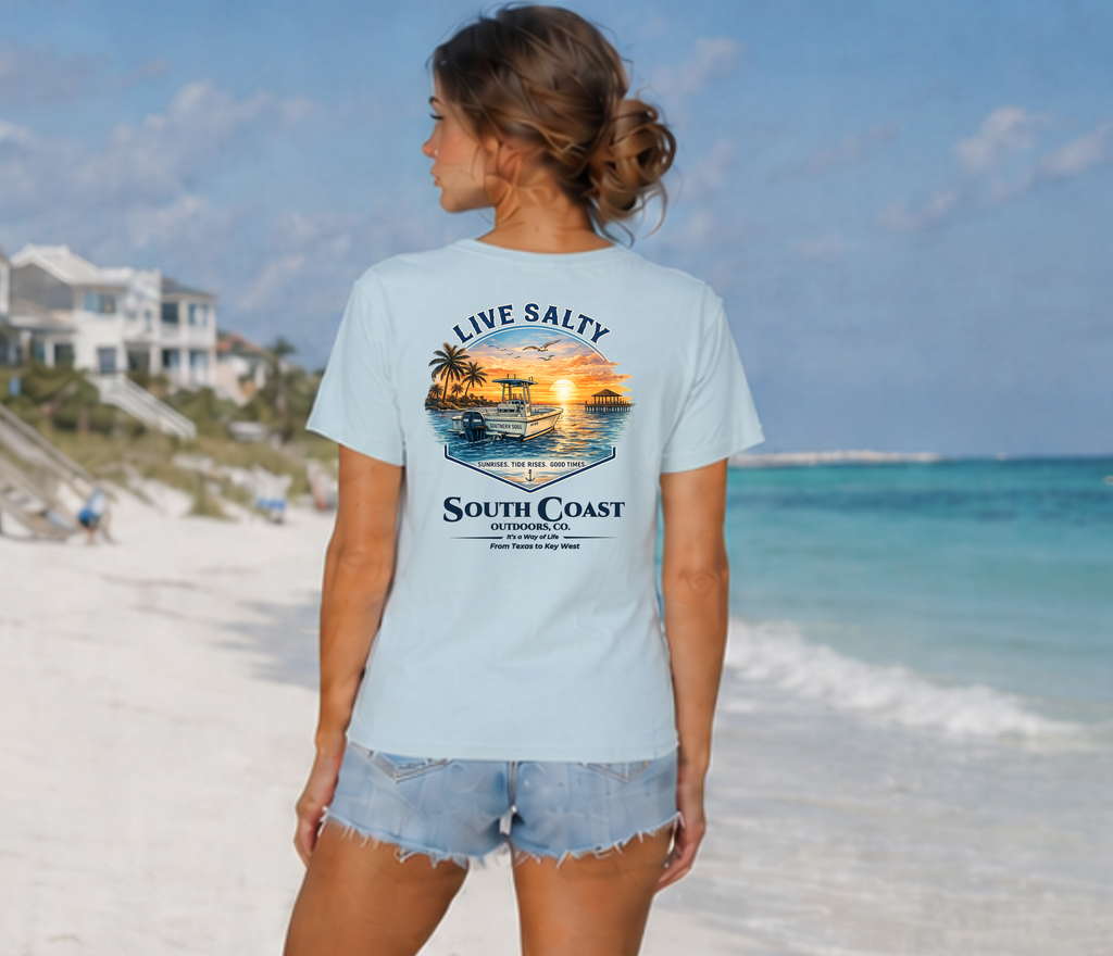Light blue graphic T-shirt on model, back view with boat-and-sunset print