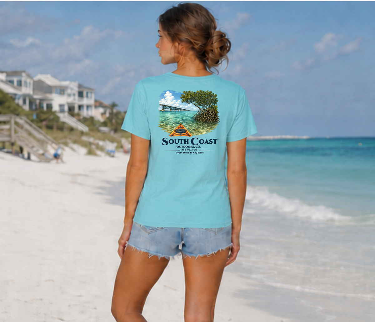 Light blue short-sleeve T-shirt worn, back print with mangrove and kayak graphic.