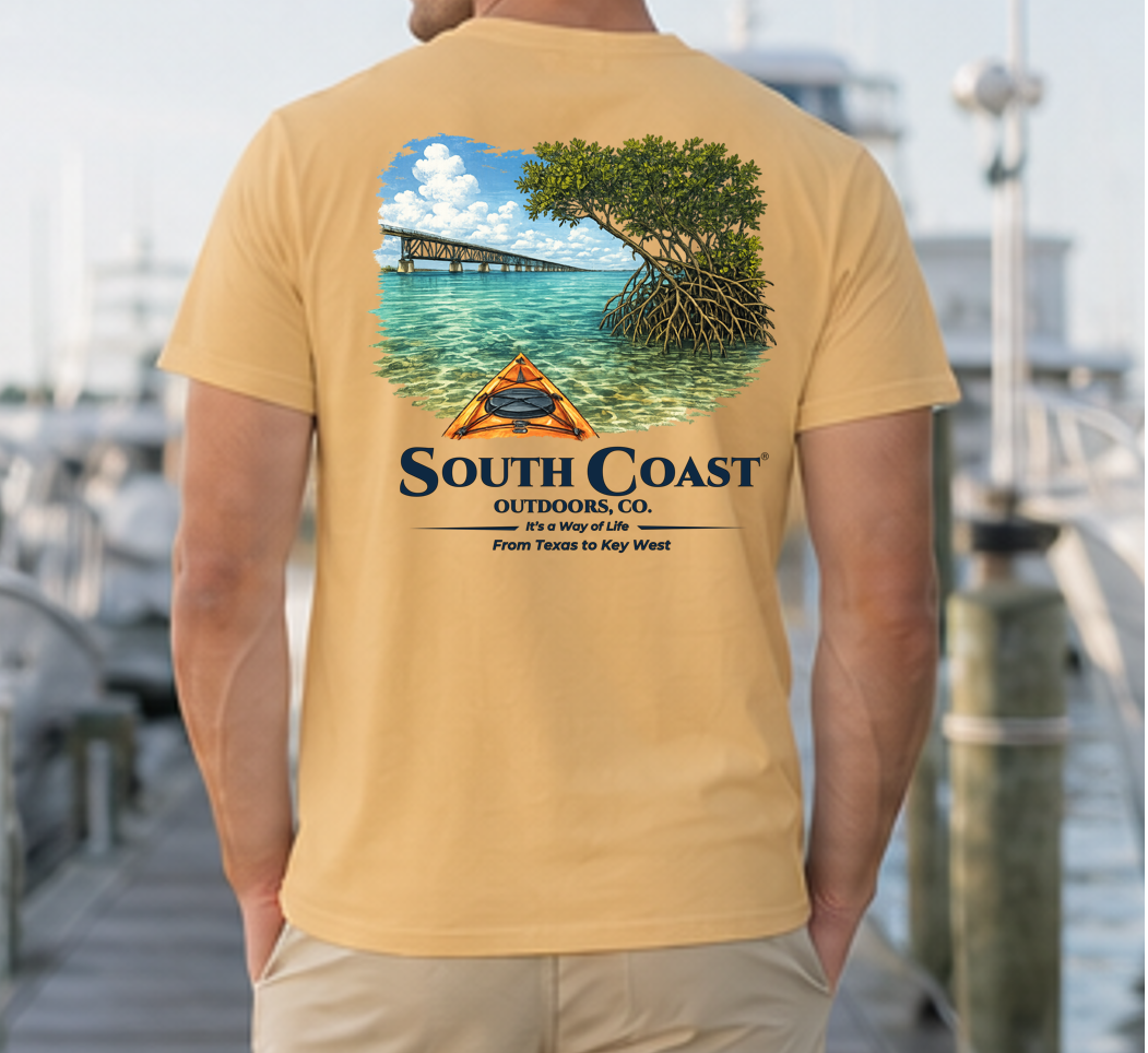 Men's tan t-shirt, back graphic of mangrove island and orange kayak shelter