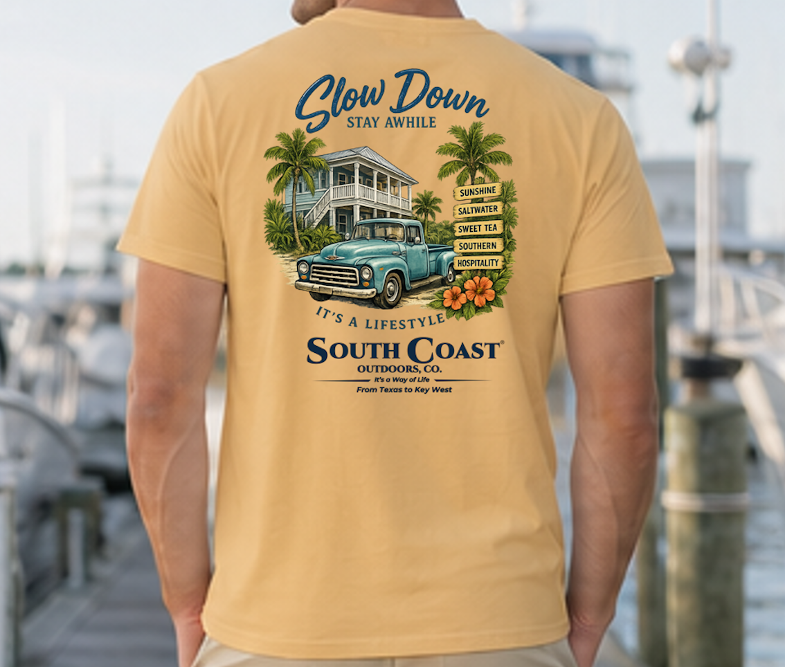 Tan graphic T-shirt with 'Slow Down' beach house and truck back print