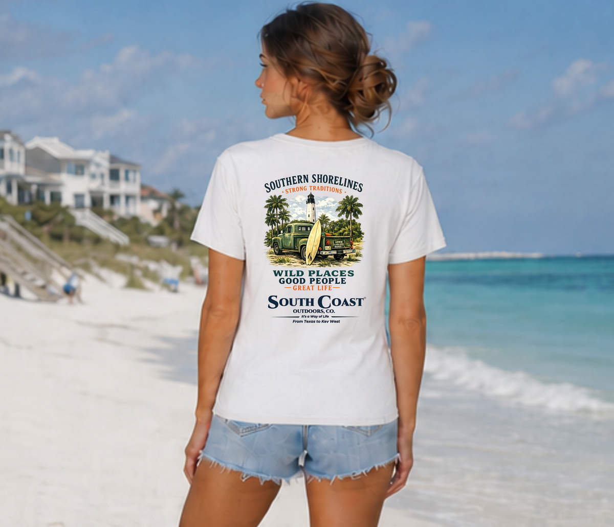 White back graphic T-shirt with palm trees, lighthouse, and “South Coast” text