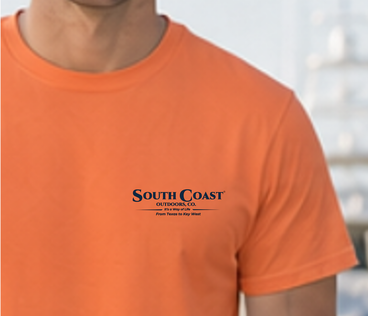 Orange Gulf Breeze T-shirt with small chest graphic: “South Coast Outdoors Co.”