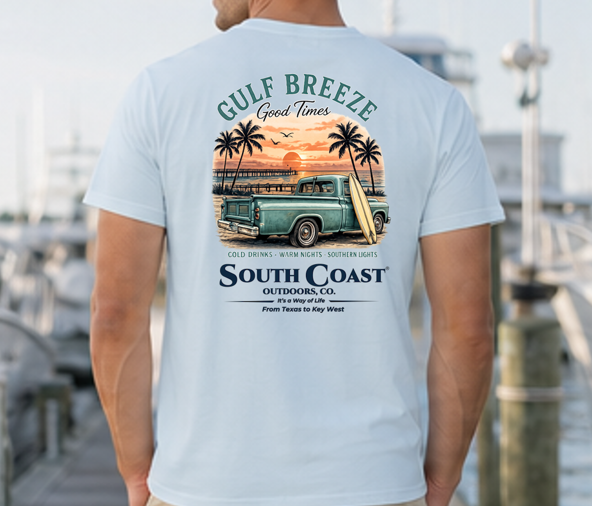 Light blue coastal graphic t-shirt, back print with truck, palm trees, and sunset