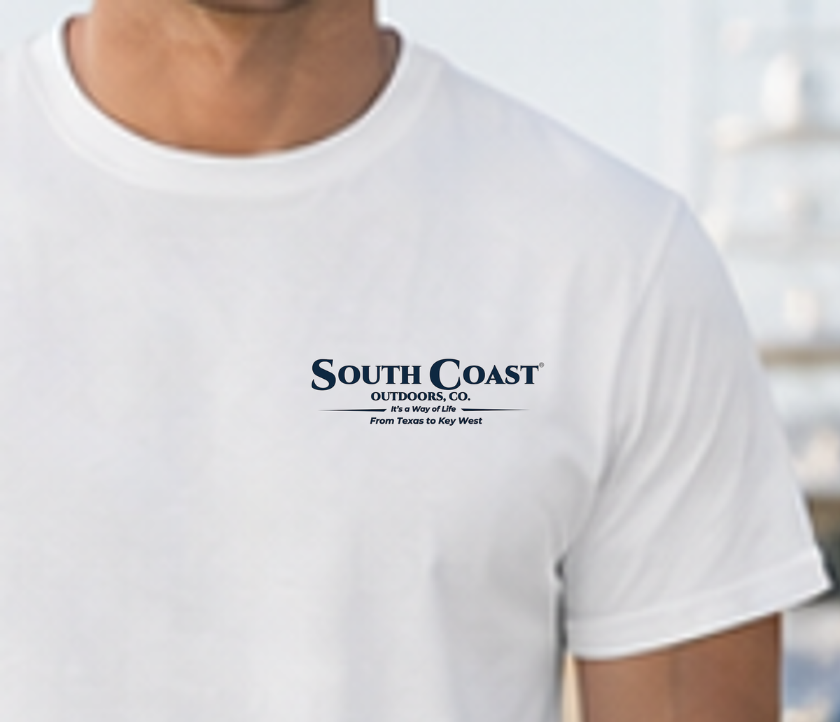White graphic T-shirt with small chest logo text reading South Coast