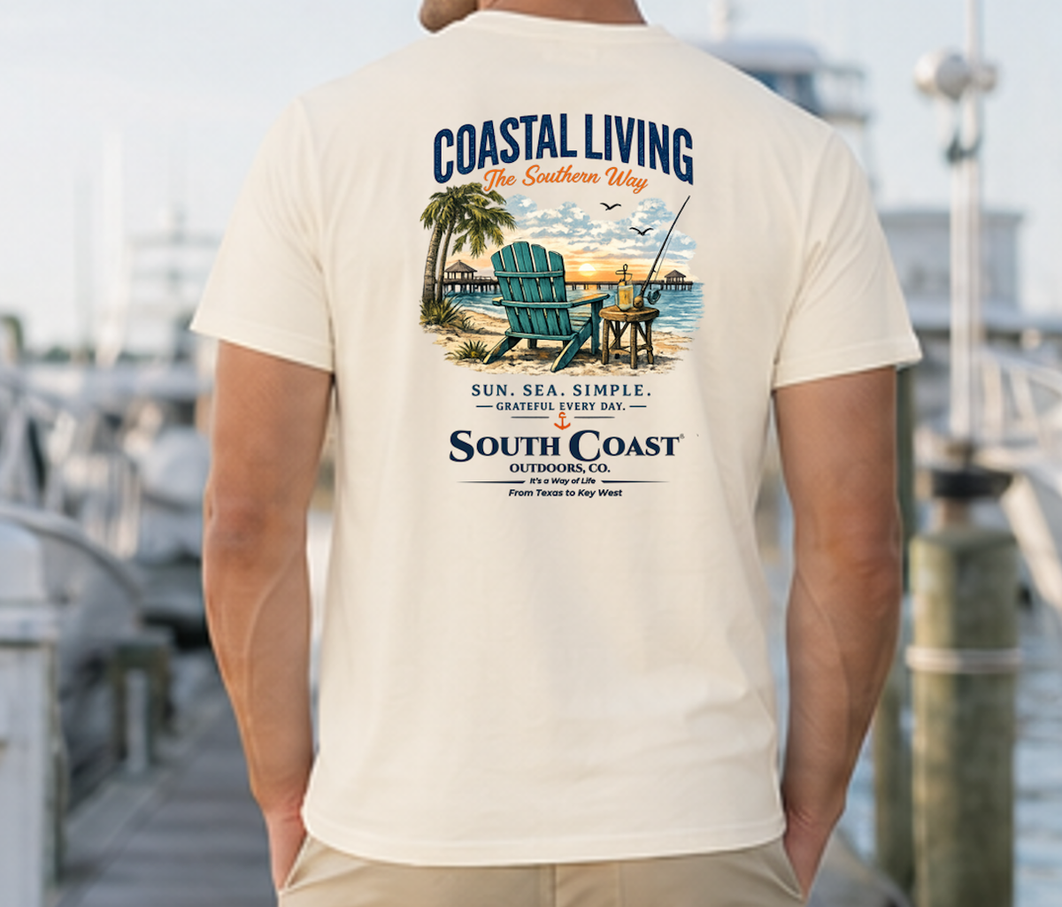 Cream Coastal Living T-shirt with large back coastal scene graphic and 'South Coast' text
