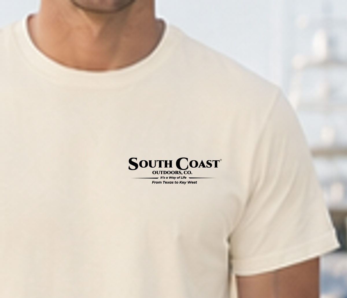 White T-shirt with small “South Coast Outdoors Co.” logo on chest