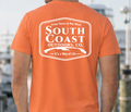 Orange T-shirt with large white South Coast Outdoors logo badge on back.