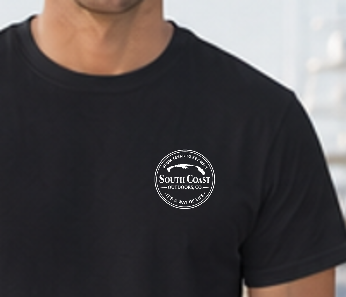 Black crewneck T-shirt with small circular South Coast logo on left chest