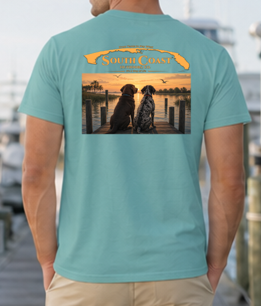 Teal T-shirt with back graphic of two dogs on dock at sunset.