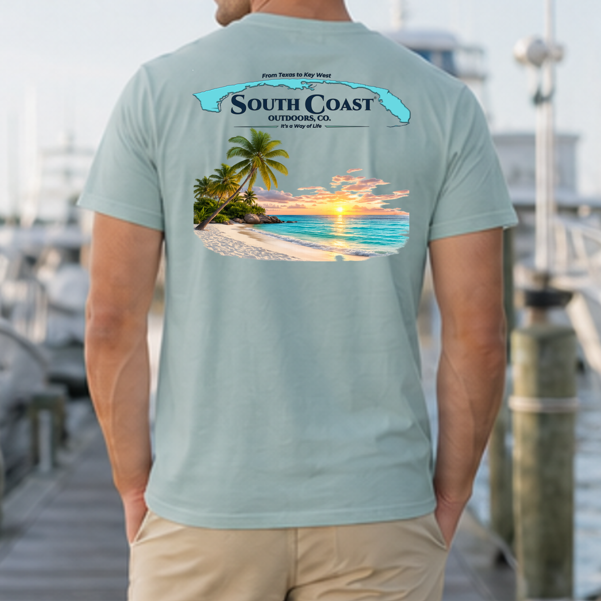 Light blue crewneck t-shirt with South Coast logo and beach sunset graphic