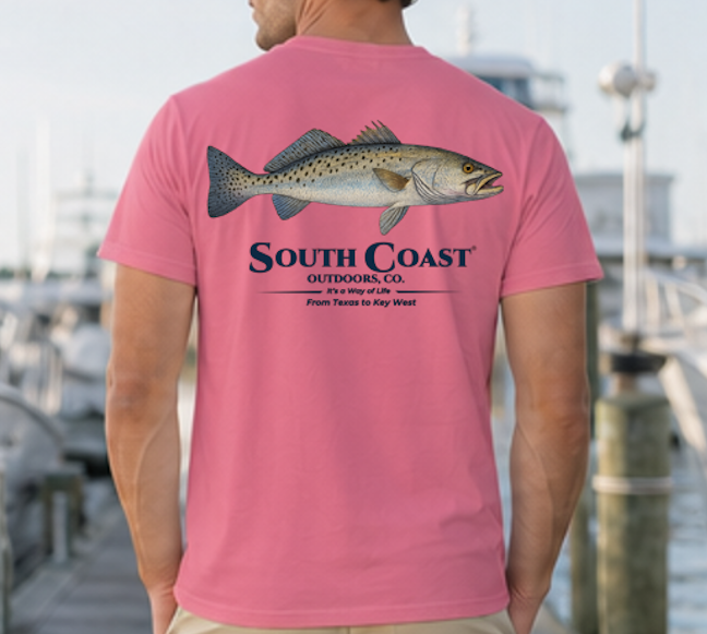 Blush pink speckled trout fishing T-shirt, back fish graphic with South Coast Outdoors logo.