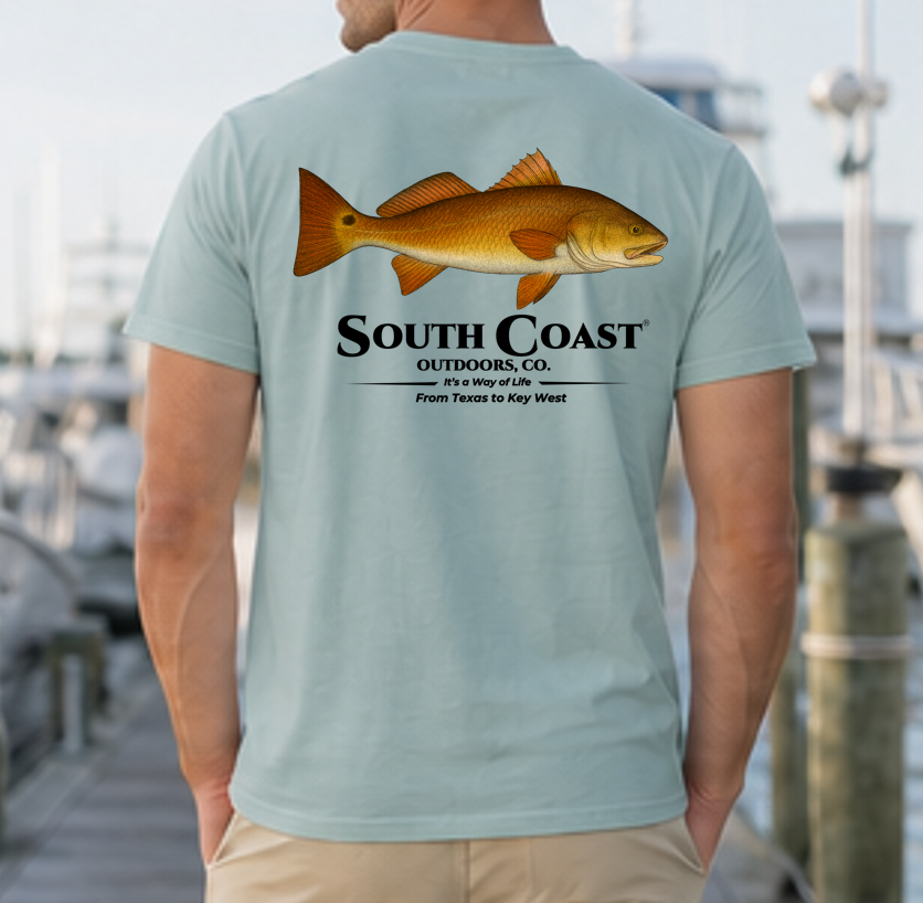 Men's dusty teal fishing graphic T-shirt with orange fish and South Coast logo on back