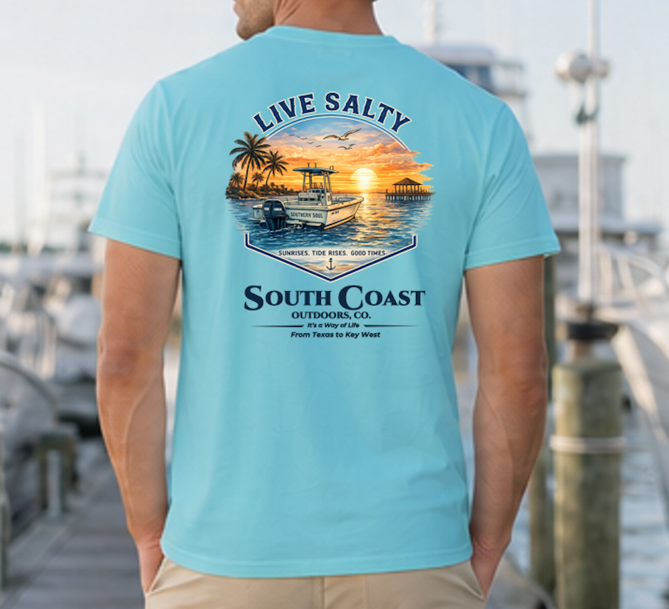 Light teal graphic t-shirt with sunset boat and palm print, 'Live Salty' text on back