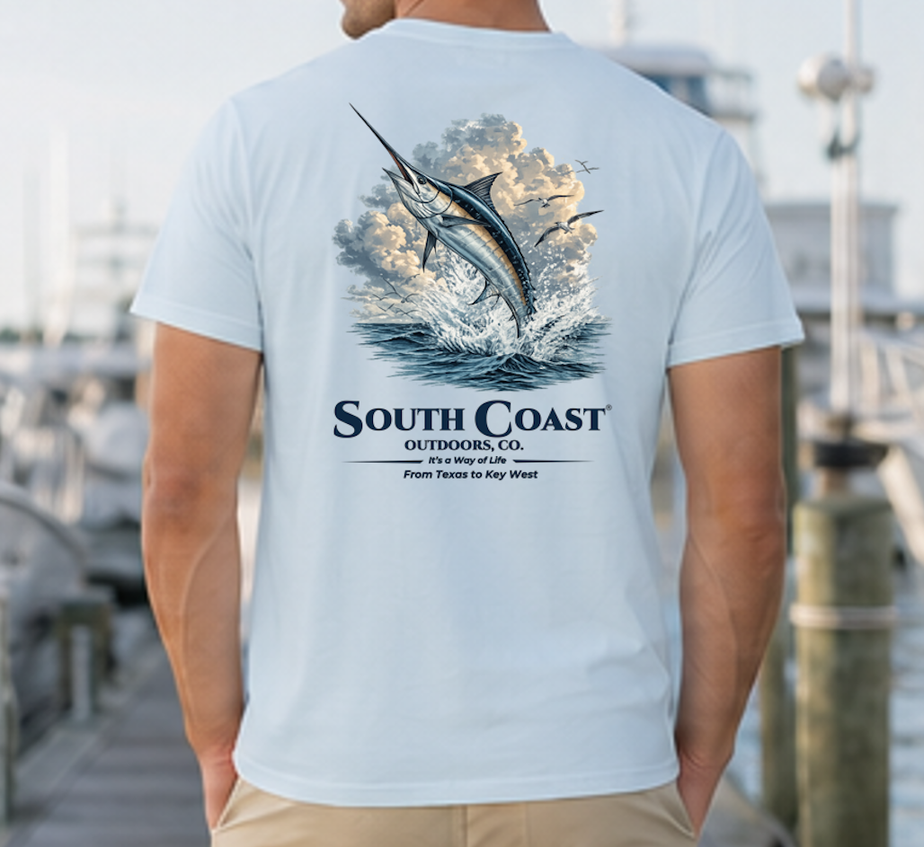 Fishing graphic t-shirt, light blue with marlin in waves and South Coast Outdoors Co text.